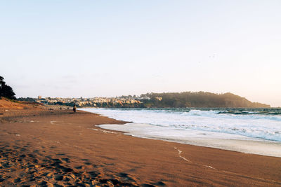 Scenic view of beach against clear sky