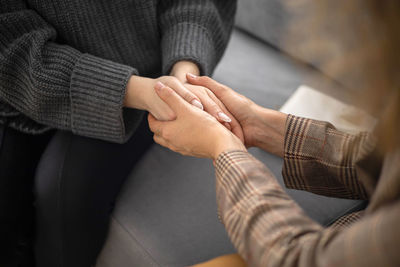 Midsection of man holding hands