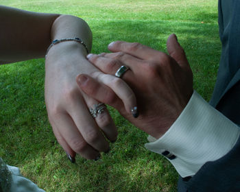 Midsection of couple holding hands