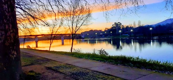 Scenic view of lake against orange sky