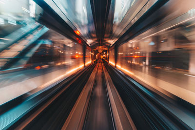 Blurred motion of train at railroad station