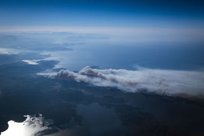 Aerial view of sea and mountains against sky