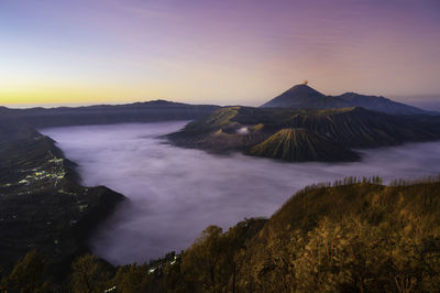 View of volcanic landscape against sky during sunset