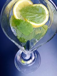 High angle view of lemon and mint leaves in lemonade glass