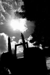Low angle view of silhouette trees against sky