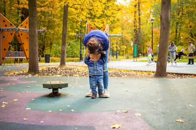 Boy playing in park during autumn