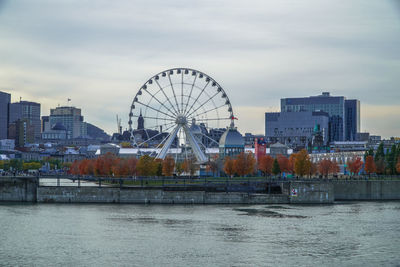 Ferris wheel in city against sky