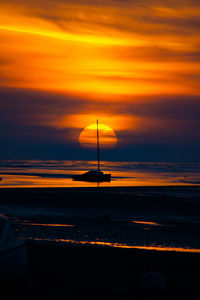 Scenic view of sea against orange sky