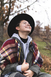 Portrait of smiling young woman in hat