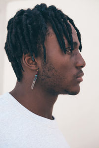 Black man with earring portrait on a monochrome background