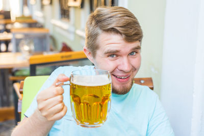 Portrait of smiling man drinking glass