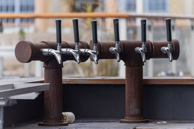 Close-up of metallic beer servers