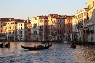 Gondolas on canal against sky