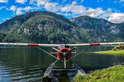 Seaplane against mountains on water