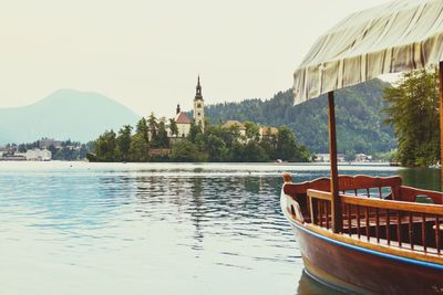 Scenic view of lake by buildings against sky