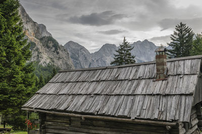 Wooden house and mountains against sky