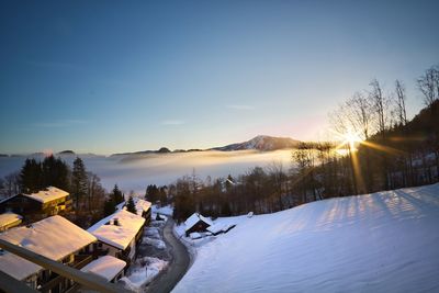 Scenic view of snow covered mountains against sky during sunset