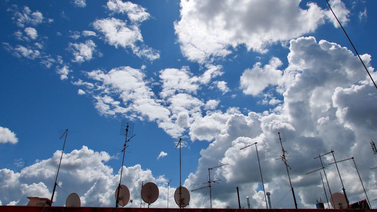 LOW ANGLE VIEW OF BUILDINGS AGAINST BLUE SKY