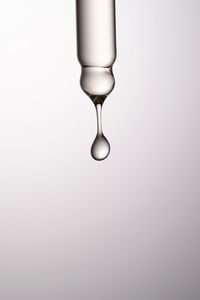 Close-up of light bulb against white background