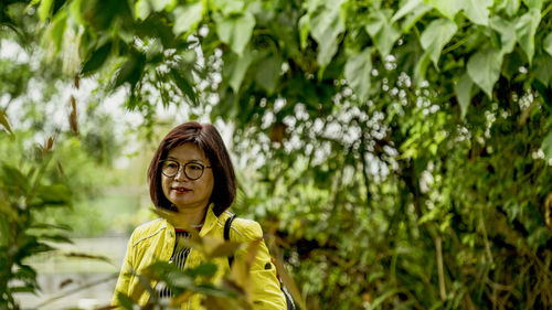 Portrait of woman against plants