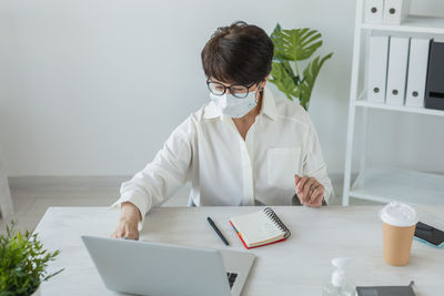 Doctor working at desk in office