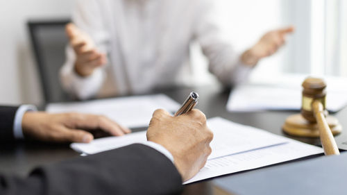 Midsection of businessman working at desk in office