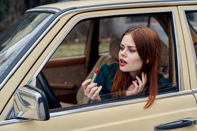 Portrait of young woman in car