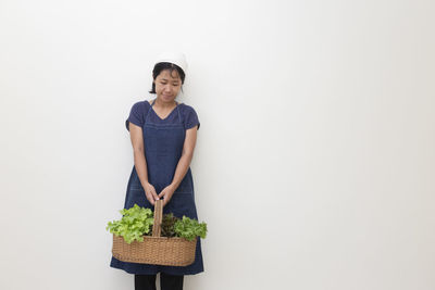 Rear view of woman standing against white background