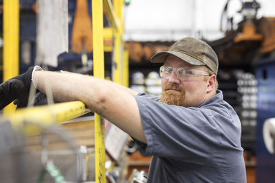 Side view portrait of worker in steel industry factory