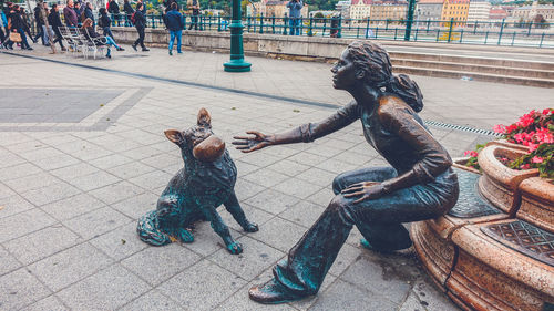 Full length of men sculpture on street in city