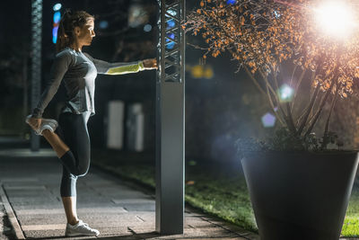 Woman stretching, late night training