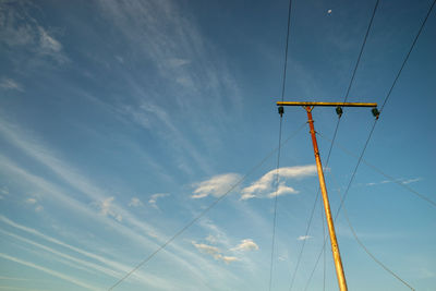 Low angle view of telephone pole against sky