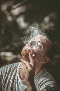 Portrait of man smoking cigarette