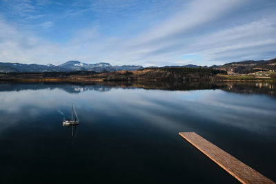 Mountain lake with sail boat.