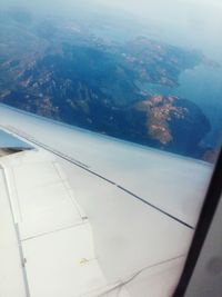 Aerial view of sea seen through airplane window