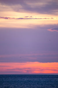 Scenic view of sea against sky at sunset