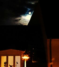 Low angle view of illuminated building against sky at night