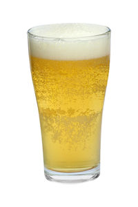 Close-up of beer glass against white background