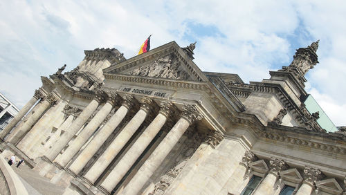 Low angle view of historical building against cloudy sky
