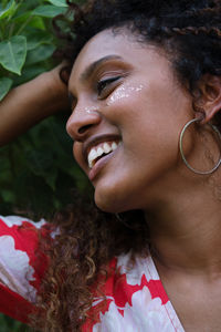 Portrait of a black woman with afro hair and glitter on her face