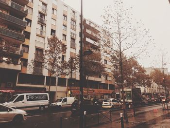 Cars on street by buildings in city