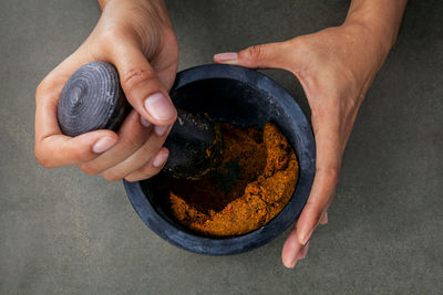 High angle view of hands making paste