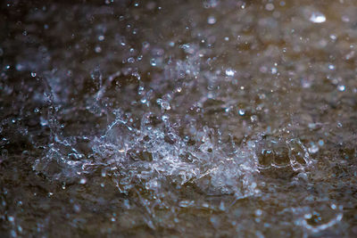 High angle view of raindrops on water