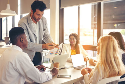 Selective focus of multi-ethnic group of young people studying together