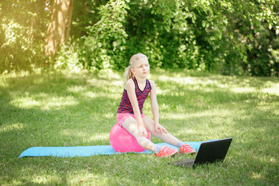 Woman using mobile phone in field