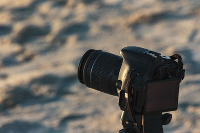 Close-up of camera on beach