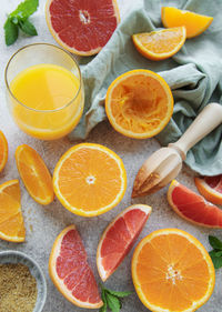 Glass of juice and fresh citrus fruits