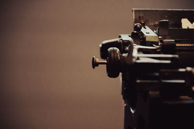 Close-up of old machine part on table