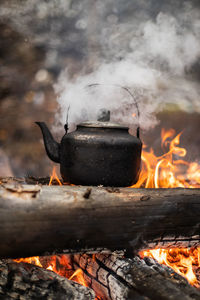 Hot steel kettle on outdoor fire.