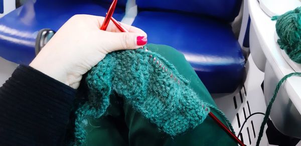 Close-up of woman hand holding blue car